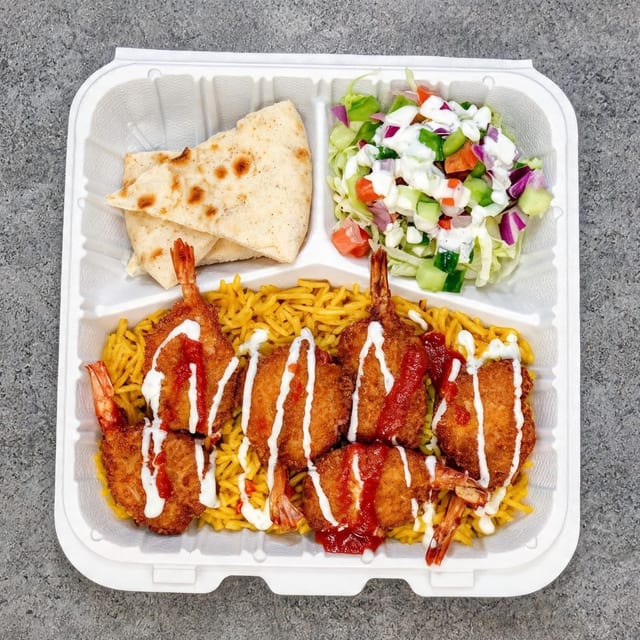 Jumbo Shrimp Over Rice with Salad and Can Soda.